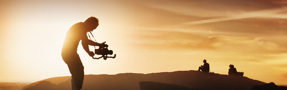 man filming at sunrise