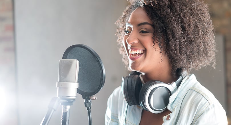 Lady smiling into microphone