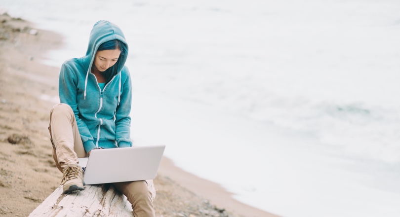 Lady at the beach on her laptop