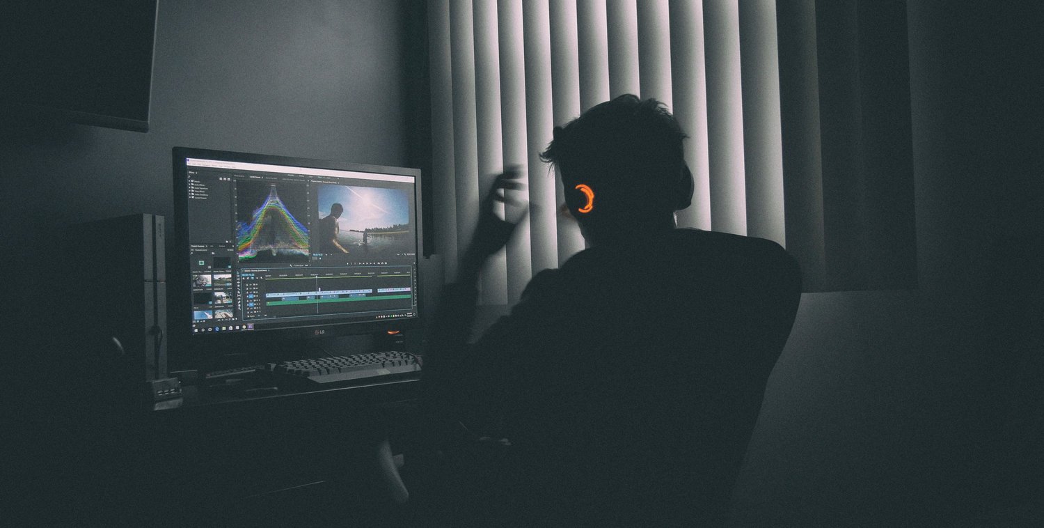 Man wearing headphones looking at screen