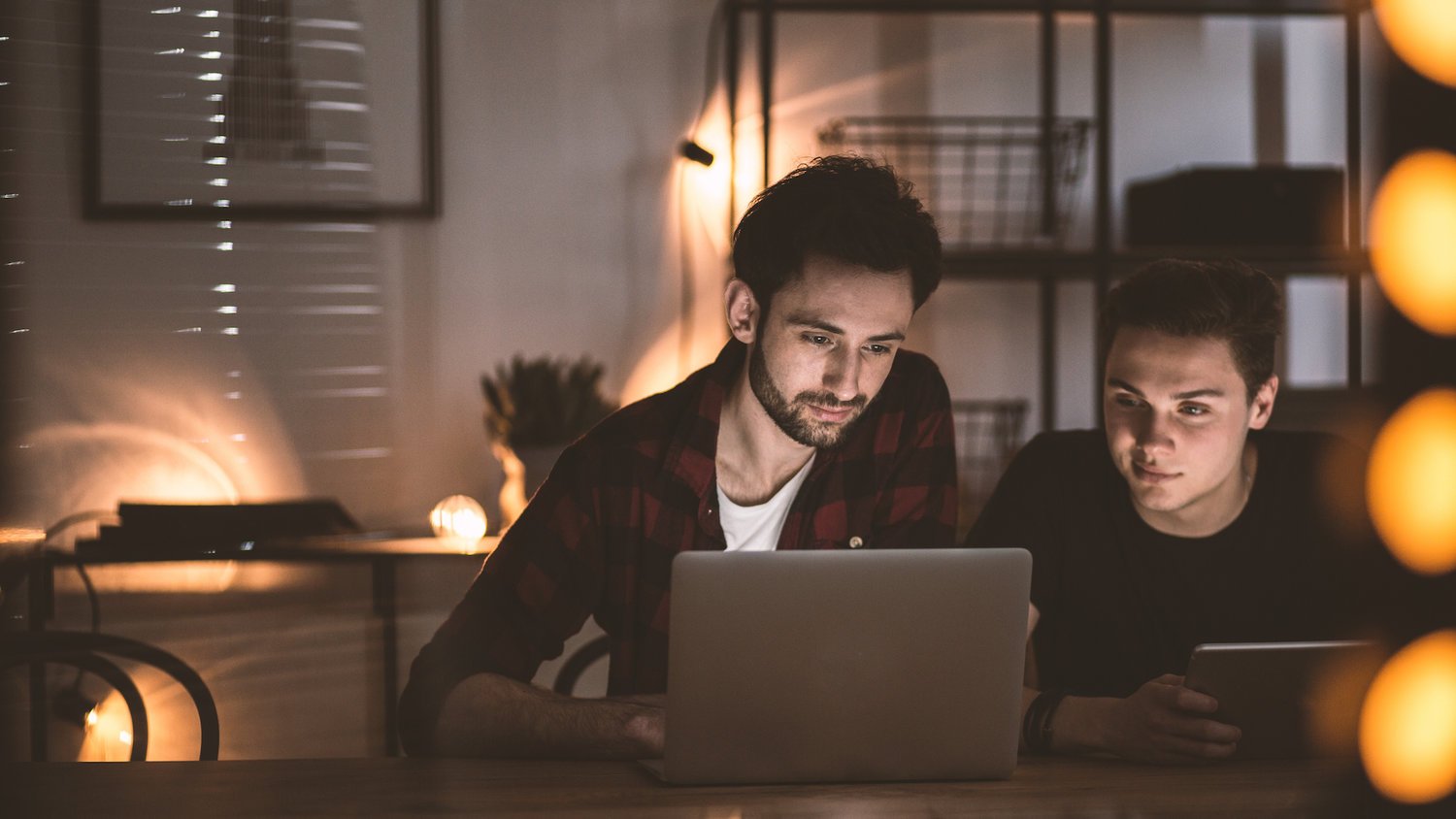 two people looking at laptop screen 