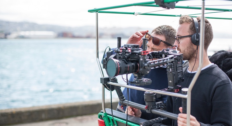 two men behind a camera